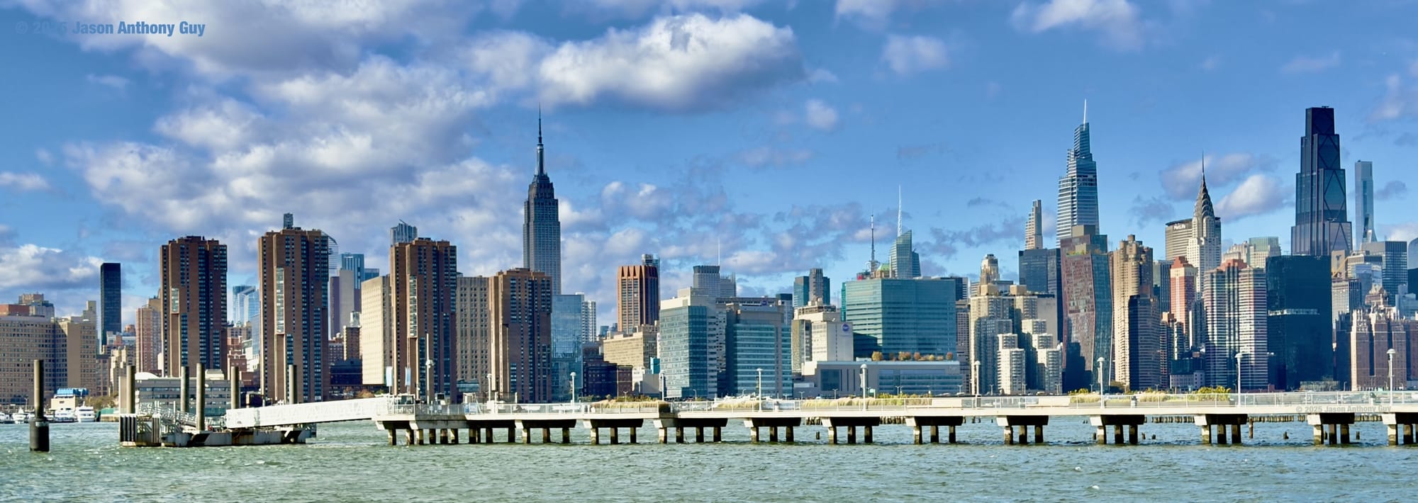 Photo of the New York City skyline taken on a bright, clear fall afternoon.